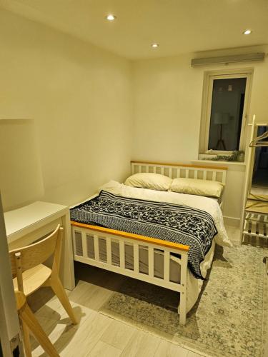 伦敦Transom Close的一间卧室配有一张床、一张书桌和一个窗户。