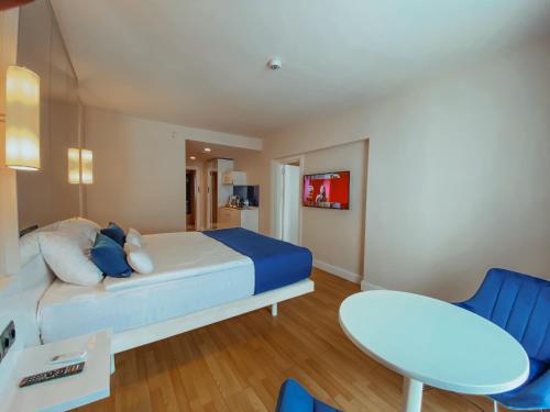 巴统Batumi VIP hotel的卧室配有1张床、1张桌子和1把椅子