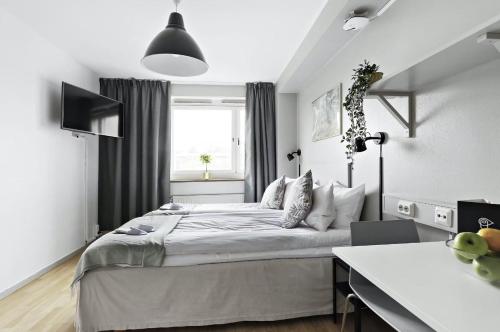 斯德哥尔摩斯德哥尔摩阿尔维克弗里农公寓式酒店的一间卧室设有一张大床和一个窗户。