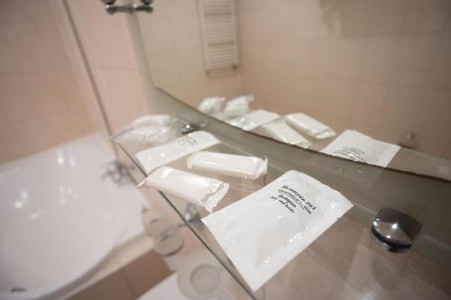 若夫克瓦Hotel Kopa - Zhovkva的浴室设有镜子、水槽和浴缸