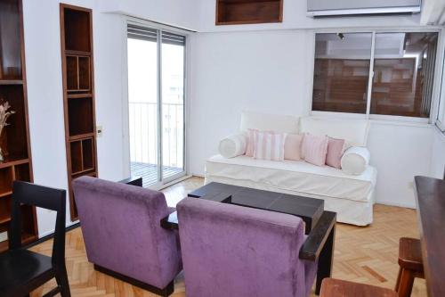 奥利沃斯Libertador 2785 by depptö的客厅配有沙发和两把紫色椅子