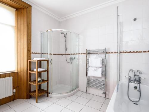 MoulinGatehouse Lodge的带淋浴和浴缸的白色浴室