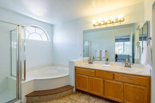 拉斯维加斯Sin City's Hidden Gems的浴室配有2个盥洗盆、浴缸和淋浴。