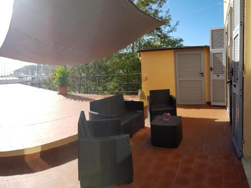 瓦拉泽La Terrazza Apartment,a 50 mt dal mare的露台配有两把椅子和一张桌子