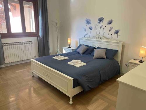 泰塞拉MarcoPoloAirport-2 camere da letto-Wifi-Netflix-15' da Venezia的一间卧室配有一张带蓝色棉被的大床