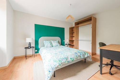 莫尔塞姆La FORGE Appartement chaleureux et Grands espaces的一间卧室设有一张床和绿色的墙壁