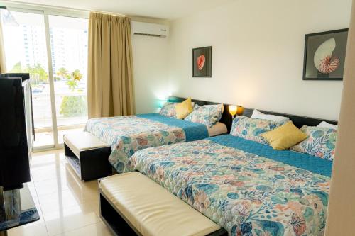 普拉亚布兰卡Hermoso estudio con vista al mar en el Town Center de Playa Blanca Panamá的一间卧室设有两张床和窗户。