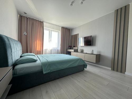 基辅Квартира з неймовірним краєвидом的一间卧室配有一张床和一台电视