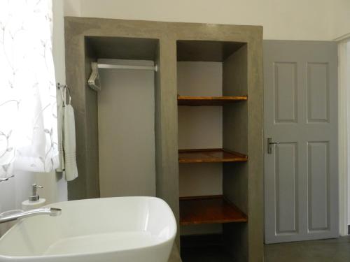 勒斯滕堡President Paul Kruger Guest Lodge的浴室配有白色浴缸和水槽