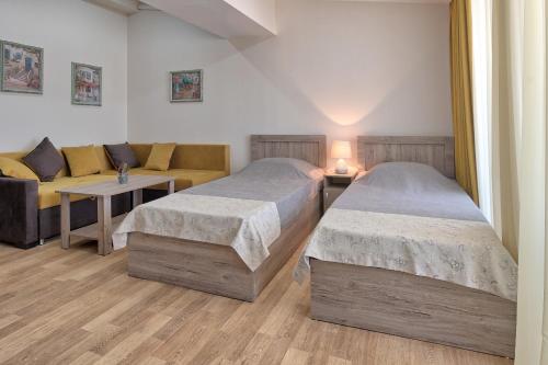 第比利斯New Tiflis Apartment Plekhanovi的一间带两张床和一张沙发的卧室