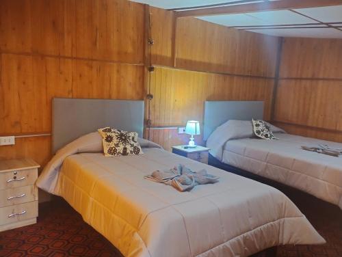 Cachorathe wooden house choquequirao的一间设有两张床的客房,上面有毛巾