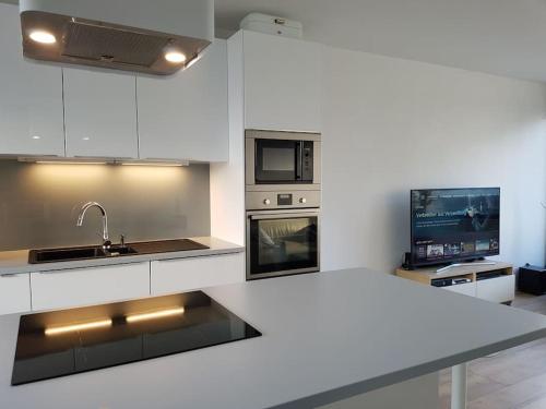 菲尔德施塔特Studio Nähe Flughafen-Messe Stuttgart的白色的厨房设有水槽和炉灶。