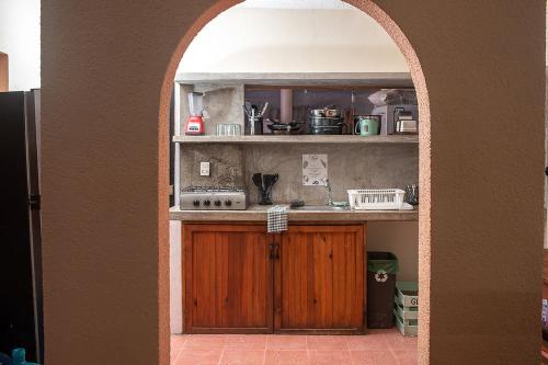 奥尔沃克斯岛Mapache Hostel & Camping的厨房设有拱门、炉灶和水槽
