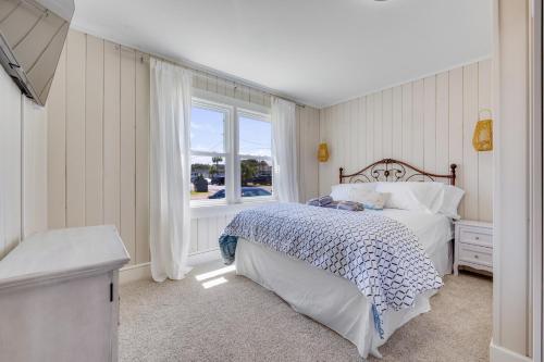 默特尔比奇200ft to beach! North Myrtle Beach first level duplex home, pet friendly!的一间卧室设有一张床和一个窗口