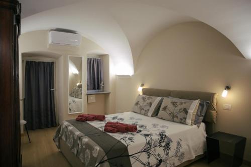 奥斯塔Aosta Romana case vacanza的一间卧室,床上有两张红色的袋子