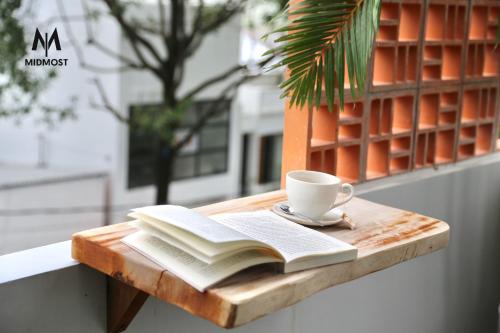 芹苴MIDMOST CASA的一本书,在木桌边喝一杯咖啡