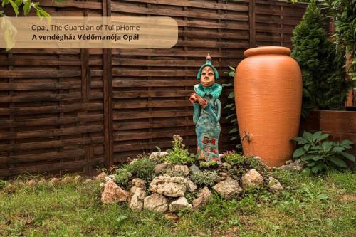 瓦茨Tulip Home Guest House的花瓶旁花园中女人的雕像