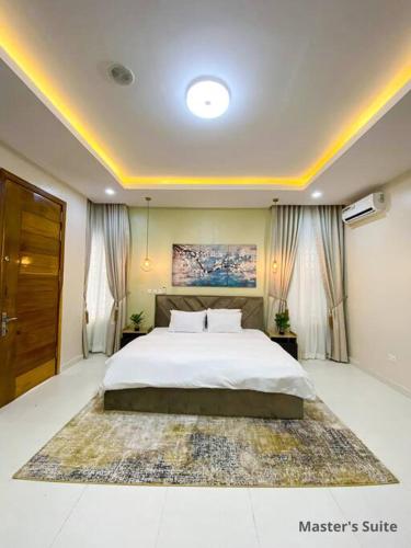 IbejuIVYs 4 Bedroom Luxury Entire Apartment Duplex with Wifi in Lekki的一间卧室配有一张大床和一张大地毯。