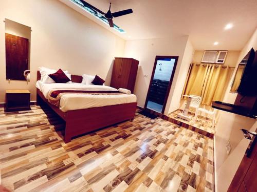 戈勒克布尔RR PALACE的一间卧室配有一张床,铺有木地板