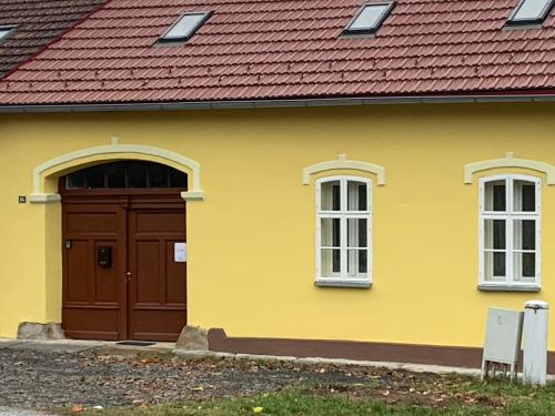 韦伯夫Zu Hause的黄色的房子,设有棕色的门和窗户