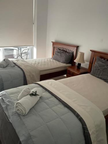 悉尼Ocean view 2 Bedroom apartment的一间卧室配有两张带毛巾的床