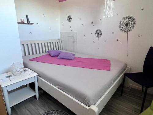 塔勒Ferienhaus am Mühlgraben的一间卧室配有一张床铺,床上铺有粉色毯子