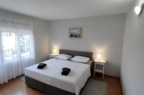 拉布Apartmani Frankic的一间卧室,配有一张带两个黑袋的床