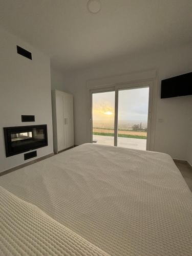 加的斯Mirador el atardecer的一间卧室设有一张大床和一个大窗户