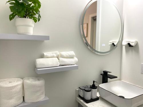 温哥华Modern and Brand new house near PNE的浴室配有盥洗盆、镜子和毛巾