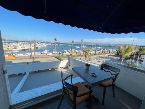 伊兹密尔Urla Marin otel的阳台享有海港景致,配有桌椅。