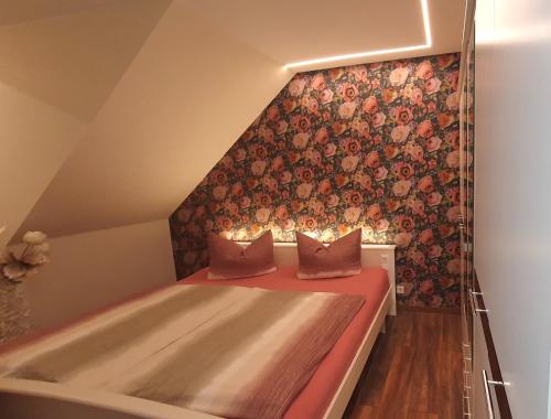 巴特萨克萨Appartementwohnung Central Bad Sachsa的一间卧室设有一张床和鲜花墙