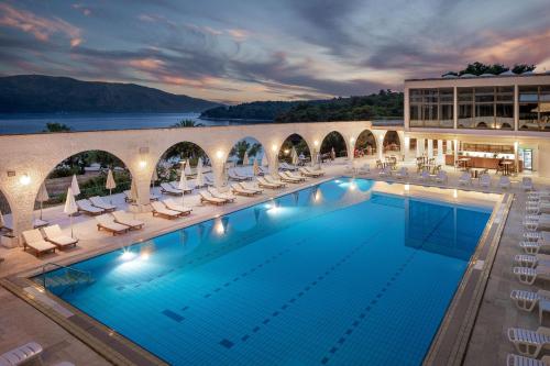 斯塔里格勒Arkada Hotel的一座带躺椅的大型游泳池和一座建筑