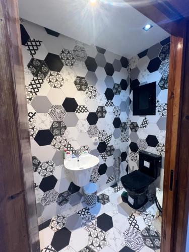 哈马马特Appartement marina hammamet的浴室铺有黑白瓷砖地板。