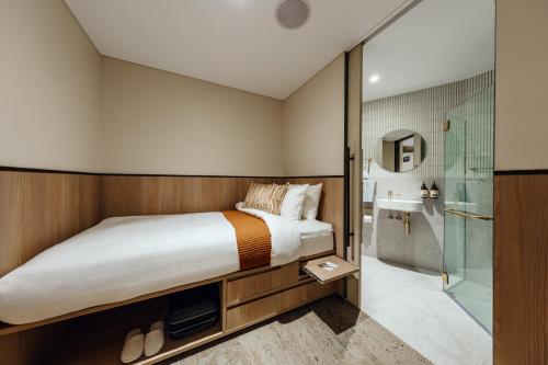 悉尼Aerotel Sydney (Arrivals B, International Terminal 1)的一间卧室配有一张床和淋浴
