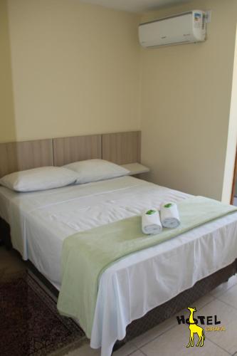伊塔蒂亚亚Hotel Girafa的一间卧室配有一张床,并备有2个拖鞋