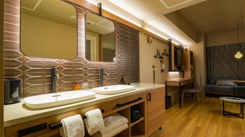 小樽GRIDS PREMIUM HOTEL OTARU的一间带两个盥洗盆和大镜子的浴室