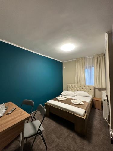 BuzăuFreedom&Relax的一间卧室设有一张床和蓝色的墙壁