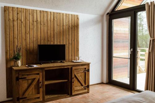 Valea DanuluiPastravaria Zavoi的客厅配有木桌上的电视