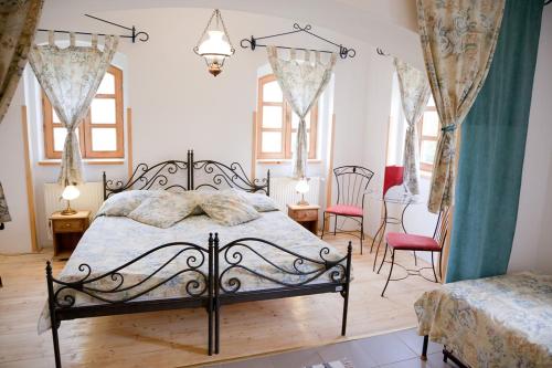 BonnyaSomogy Kertje Üdülőfalu és Étterem的一间卧室配有一张床、两把椅子和窗户
