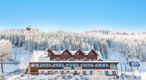 斯托尼拉斯奇Karczma Czarna Góra - Czarna Góra Resort的一座拥有雪覆盖树木的滑雪场建筑