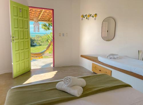 库穆鲁沙蒂巴Canto do Mar - Chalés com vista pro Mar - Cumuruxatiba的客房设有两张床和一扇窗户的门