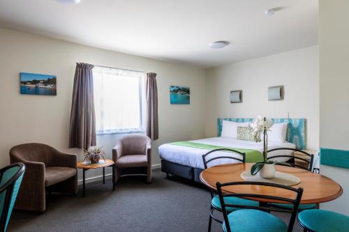 惠灵顿贝亚维斯塔汽车旅馆－惠灵顿的酒店客房带一张床、一张桌子和椅子