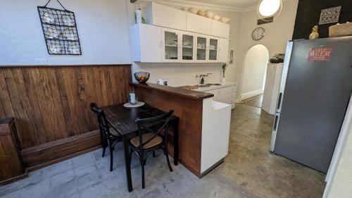 珀斯Hatbox House的厨房配有桌子和冰箱