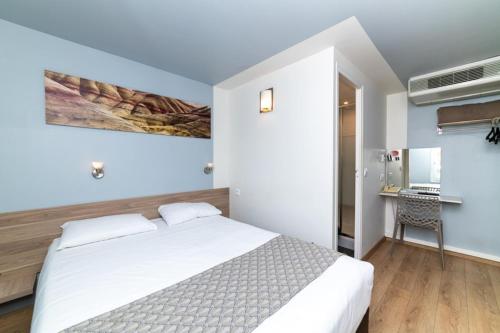 马孔Brit Hotel Macon Nord Autoroute du Soleil的卧室配有白色的床和桌椅