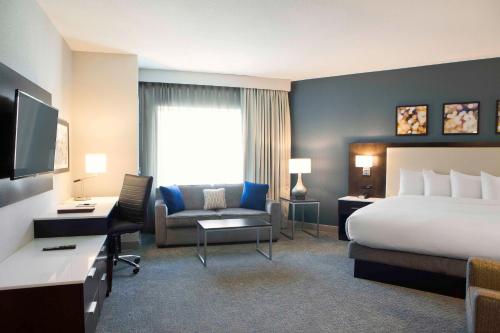 明尼阿波利斯Hilton Garden Inn Minneapolis - University Area的酒店客房配有一张床、一张桌子和一把椅子。