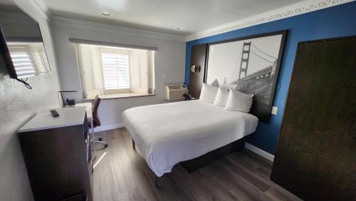 旧金山Signature Inn San Francisco Marina District的酒店客房设有一张大床和一座桥