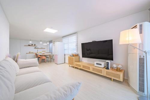 襄阳郡Zio Pinetree的白色的客厅配有电视和沙发