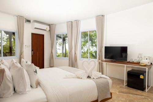 涛岛The AVA Resort Koh Tao的一间白色卧室,配有床和电视