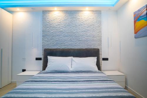 奥尔比亚Blue Island - Luxury House的一间卧室设有一张床和砖墙