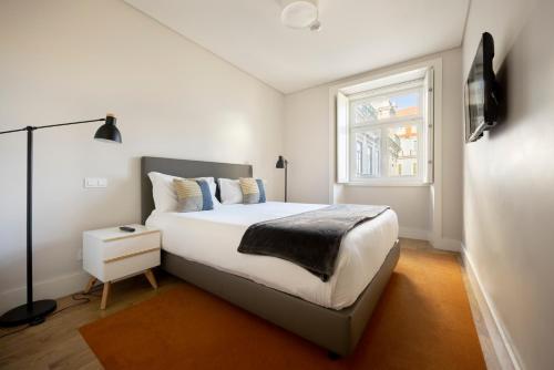 里斯本希亚多广场公寓 | 里斯本百斯特公寓的白色的卧室设有床和窗户
